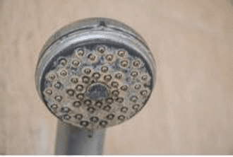 A shower head corroded from hard water.