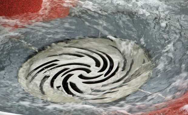 After drain cleaning, the water is flowing down the drain.