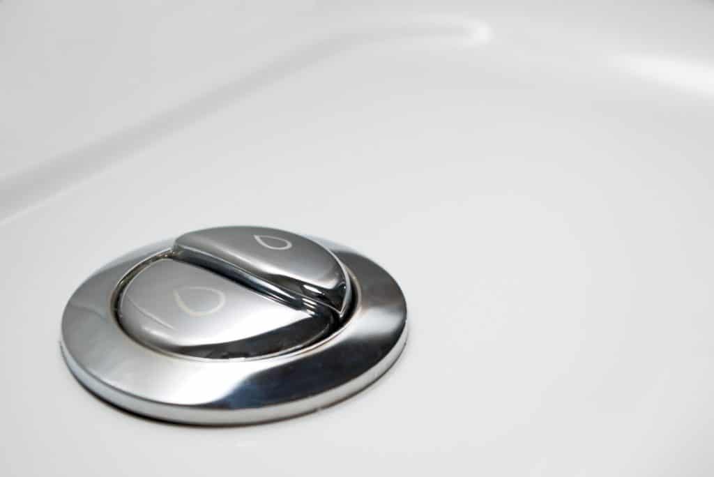 Plumbing fixtures: Economical toilet flush knob with dual buttons for low-flow toilets.
