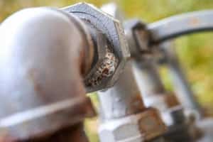 Soap bubble test for gas leaks in pipes.
