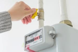 A homeowner shuts off their gas supply at the meter.