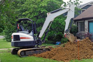 A team digs a trench to replace a Dallas home's water line.