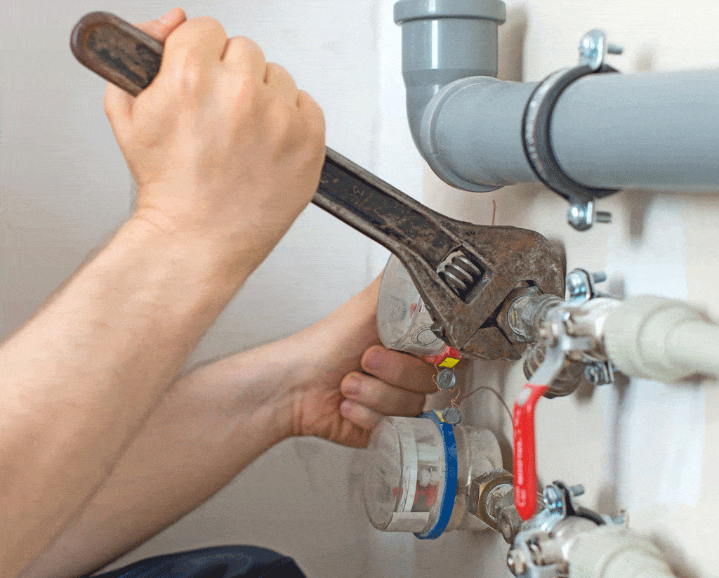 man using wrench to tighten pipe plumbing service plano tx dallas tx