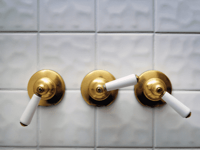 Three shower handles with the middle being the diverter.