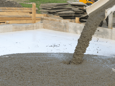 Wet concrete is poured for a home foundation.
