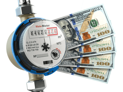 A water meter with money fanned out from the side.