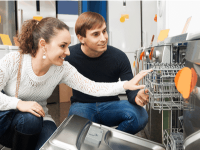 A young couple shops for a new dishwasher.