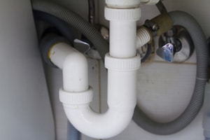 Garbage disposal trap under a sink