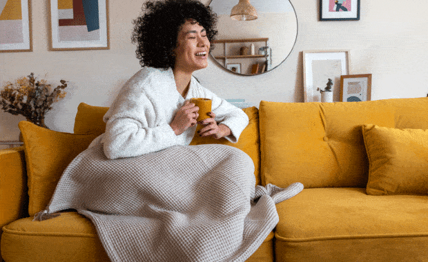 girl sitting on ouch with blanket and coffee water heater installaton service plano tx dallas tx