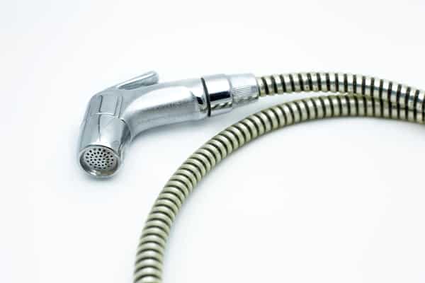 bidet shower head on white background