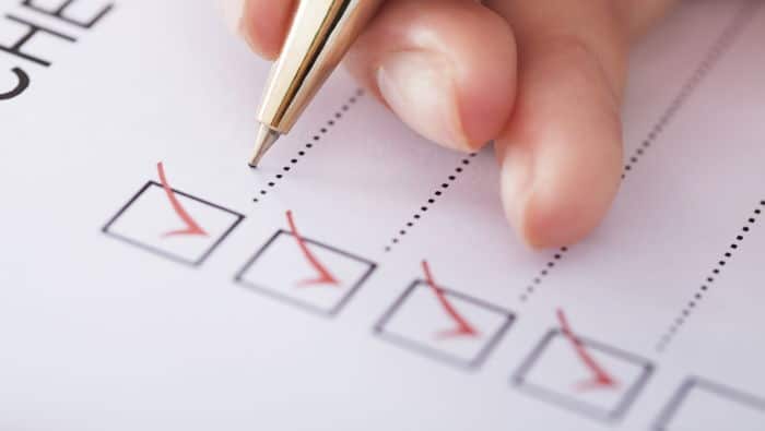 A pen crosses off items on a checklist.