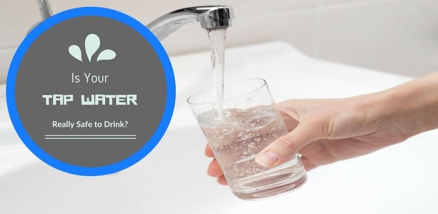 Person at sink filling up glass with tap water from sink's faucet. "Is your tap water really safe to drink?"