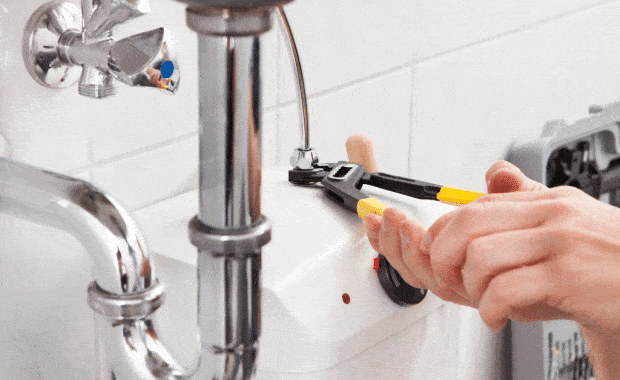 male plumber using a wrench to tighten pipes dallas tx frisco tx carrollton tx