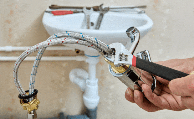 plumber installing sink faucet onto sink plumbing fixture installation plano tx dallas tx