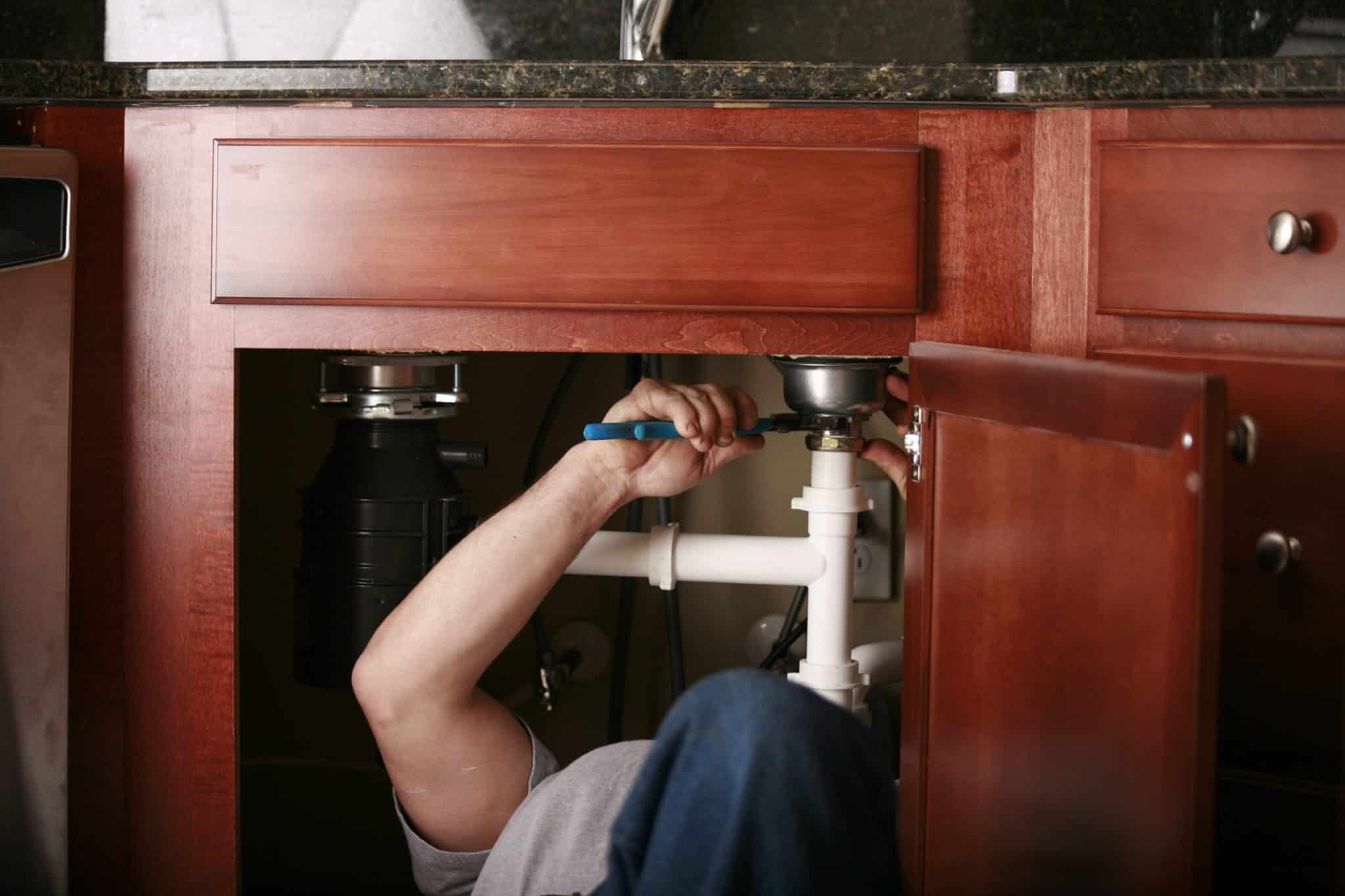 plumbing maintenance under kitchen sink