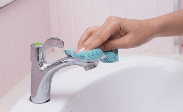 Scrubbing rust stains from faucet