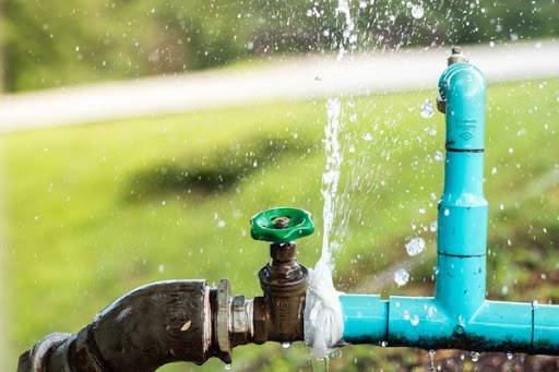 water bursting from outdoor faucet