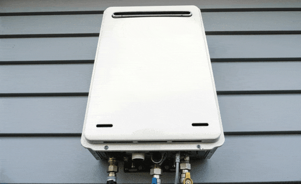 tankless water heater on wall outside of grey house tankless water heater installation dallas tx carrollton tx