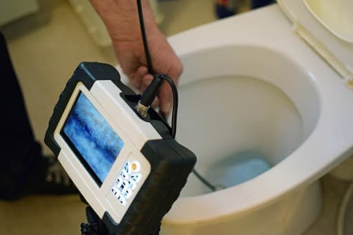 A video monitor records a plumbing inspection camera.
