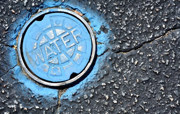water main access pipe in concrete painted blue